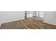 Spacious living room area with wood-look flooring leading into the open kitchen at 5742 E Smeaton Pl, San Tan Valley, AZ 85140