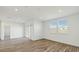 Bright living room featuring wood-look tile flooring and a sliding glass door at 5742 E Smeaton Pl, San Tan Valley, AZ 85140