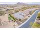 Expansive aerial view of the home, highlighting its proximity to the neighborhood, mountains, and street at 6130 E Bramble Berry Ln, Cave Creek, AZ 85331