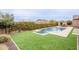 Backyard with a pool, spa, turf area, and an outdoor kitchen and dining at 6130 E Bramble Berry Ln, Cave Creek, AZ 85331
