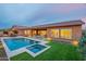 Home exterior showing a pool, spa, covered patio, and lush landscaping at 6130 E Bramble Berry Ln, Cave Creek, AZ 85331