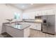Modern kitchen with granite countertops, stainless steel appliances, and white cabinetry for ample storage at 6130 E Bramble Berry Ln, Cave Creek, AZ 85331
