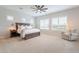 Inviting main bedroom with plush carpet, ceiling fan, large windows, and a cozy sitting area at 6130 E Bramble Berry Ln, Cave Creek, AZ 85331