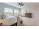 Bright main bedroom featuring a king bed, ceiling fan, and natural light from the large windows at 6130 E Bramble Berry Ln, Cave Creek, AZ 85331