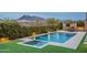 Backyard pool and spa with lush landscaping, outdoor dining, and mountain views at 6130 E Bramble Berry Ln, Cave Creek, AZ 85331