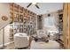 Inviting living room with custom floor-to-ceiling bookshelves, plush armchairs, and warm, neutral tones at 715 E Blossom Rd, San Tan Valley, AZ 85143