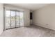Cozy bedroom with neutral carpet and sliding glass doors leading to a balcony at 715 S Extension Rd # 70, Mesa, AZ 85210