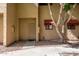Townhouse exterior with well-maintained landscaping and decorative door at 715 S Extension Rd # 70, Mesa, AZ 85210