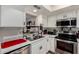Well-maintained kitchen with white cabinetry, stainless steel appliances, and eat-in area at 715 S Extension Rd # 70, Mesa, AZ 85210
