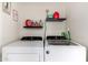 Laundry area with a side by side washer and dryer and shelving above at 715 S Extension Rd # 70, Mesa, AZ 85210