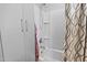 Shower and tub combination with white tile, a shower curtain and cabinet at 7771 W Cinder Brook Way, Florence, AZ 85132