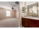 Bathroom suite featuring bedroom view, ceiling fan and a vanity with ample counter space at 7838 W Palm Ln, Phoenix, AZ 85035