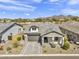Aerial view of a charming one-story home with a brick-paved driveway and a two-car garage at 8140 E June St, Mesa, AZ 85207