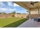 Spacious backyard featuring lush artificial grass, a telescope, and a covered patio, perfect for outdoor enjoyment at 8140 E June St, Mesa, AZ 85207