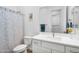 Modern bathroom with neutral walls, tile floors, a vanity with sink, and a shower/tub combo with a decorative shower curtain at 8140 E June St, Mesa, AZ 85207