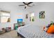 Bedroom features a ceiling fan, a TV, a window, carpeted floor and some toys at 8140 E June St, Mesa, AZ 85207