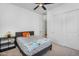 Bright bedroom features a ceiling fan, carpeted floors and some toys on the bed at 8140 E June St, Mesa, AZ 85207