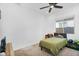 Bedroom features a bed, a window, carpeted floor and a ceiling fan at 8140 E June St, Mesa, AZ 85207