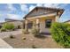 Beautiful home with a desert landscape, brick accents, and a paved driveway for added elegance at 8140 E June St, Mesa, AZ 85207