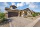 Stunning home featuring a spacious driveway, a well-kept lawn, and tasteful landscaping at 8140 E June St, Mesa, AZ 85207