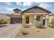 Charming single-story home with desert landscaping, brick accents, and a spacious two-car garage at 8140 E June St, Mesa, AZ 85207