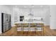 Modern kitchen with stainless steel appliances, a large island, and sleek white cabinetry at 8140 E June St, Mesa, AZ 85207
