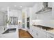 Modern kitchen boasts stainless appliances, quartz countertops, white cabinetry, and a sleek gas cooktop at 8140 E June St, Mesa, AZ 85207