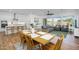 Open-concept living area featuring a dining table, sofas, and lots of natural light from large windows at 8140 E June St, Mesa, AZ 85207