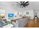 Spacious living room with tile floors, a ceiling fan, a comfortable seating area and direct access to the dining room at 8140 E June St, Mesa, AZ 85207