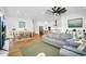 Open-concept living room featuring wood floors, neutral decor, and seamless access to the kitchen at 8140 E June St, Mesa, AZ 85207