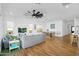 Living area with wood floors, a ceiling fan, lots of lights, and windows at 8140 E June St, Mesa, AZ 85207