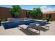 Inviting pool area with lounging chairs and landscaped planters perfect for relaxation at 8140 E June St, Mesa, AZ 85207