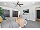 Spacious bedroom featuring a ceiling fan, tv, walk in closet, and an ensuite bathroom at 821 W Kiva Ave, Mesa, AZ 85210