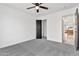 This bedroom includes plush carpet, a ceiling fan and black closet doors at 821 W Kiva Ave, Mesa, AZ 85210