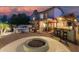 Inviting backyard with a fire pit, outdoor kitchen, patio, and lush landscaping, perfect for entertaining at 826 W Royal Palms Dr, Gilbert, AZ 85233