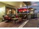 Inviting backyard patio with outdoor kitchen, seating, and a red umbrella under a blue sky at 826 W Royal Palms Dr, Gilbert, AZ 85233