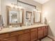 Double vanity bathroom with granite countertops and decorative mirrors at 826 W Royal Palms Dr, Gilbert, AZ 85233