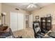 Neutral-toned bedroom features a closet, shelf and dark desk chair at 826 W Royal Palms Dr, Gilbert, AZ 85233