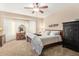 Cozy bedroom features neutral tones, plush carpeting, and ample natural light from large bay windows at 826 W Royal Palms Dr, Gilbert, AZ 85233