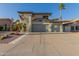 Well-maintained two-story home with a spacious three-car garage and mature landscaping under clear skies at 826 W Royal Palms Dr, Gilbert, AZ 85233