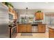 Well-lit kitchen featuring stainless steel appliances, granite countertops, and a view of the backyard at 826 W Royal Palms Dr, Gilbert, AZ 85233