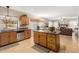 Open-concept kitchen with stainless steel appliances and granite countertops open to the breakfast nook and living room at 826 W Royal Palms Dr, Gilbert, AZ 85233
