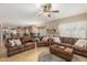Expansive living room with tile floors and comfortable leather seating open to the kitchen and dining areas at 826 W Royal Palms Dr, Gilbert, AZ 85233