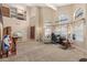 Bright living room with vaulted ceilings, large windows, comfortable seating, and easy access to the front entrance at 826 W Royal Palms Dr, Gilbert, AZ 85233