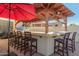 Outdoor kitchen featuring a built-in grill, bar seating, and a covered structure for alfresco dining at 826 W Royal Palms Dr, Gilbert, AZ 85233