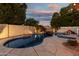 A sparkling pool with a rock waterfall feature, framed by lush landscaping for a relaxing outdoor space at 826 W Royal Palms Dr, Gilbert, AZ 85233