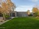 Lush backyard with a pristine lawn, modern exterior, mature trees, and a contemporary design at 8433 E Cholla St, Scottsdale, AZ 85260