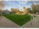 Expansive backyard featuring lush green lawn, mature trees, and a tranquil setting at 8433 E Cholla St, Scottsdale, AZ 85260