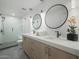 Modern bathroom featuring a double vanity, walk-in shower, and pendant lighting at 8433 E Cholla St, Scottsdale, AZ 85260