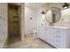 Bright bathroom with a travertine shower and a white double vanity at 8433 E Cholla St, Scottsdale, AZ 85260